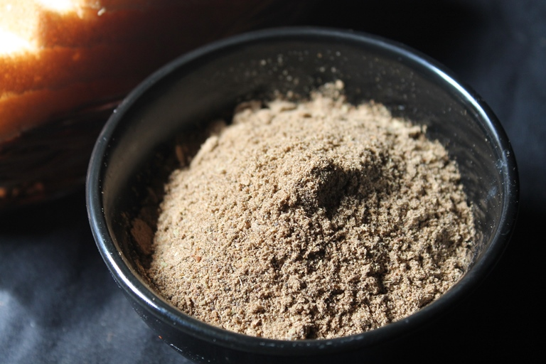 Brown-colored powder in a black bowl